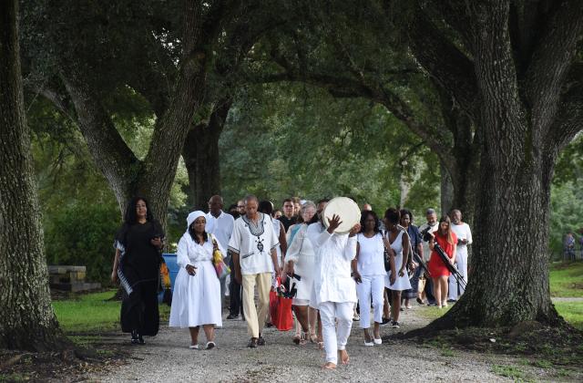 Descendants, RSCJ and guest process to the monuments in the cemetery adjacent to St. Charles Borromeo